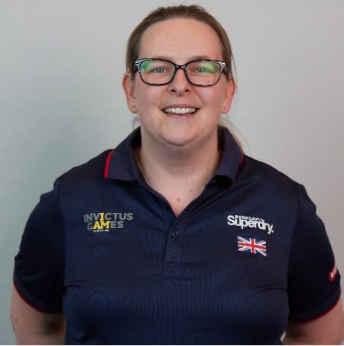 Personnel wears Invictus Games uniform in portrait.